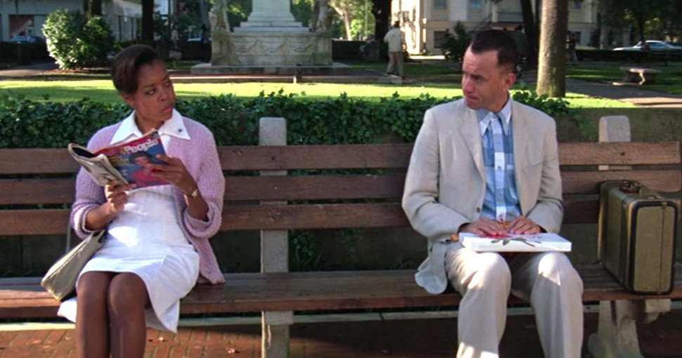 Forest Gump sitting on a bench with a woman